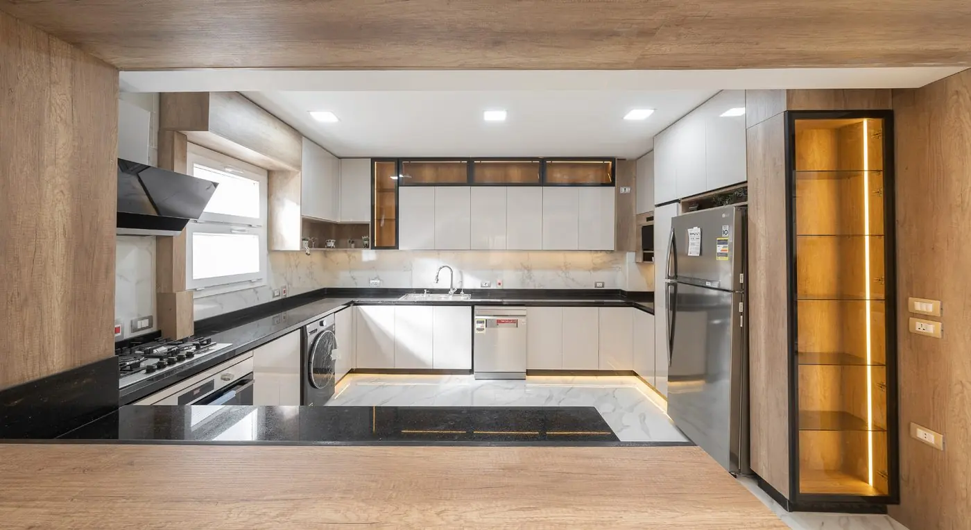 Kitchen in warm wood and black stone in 6th of October